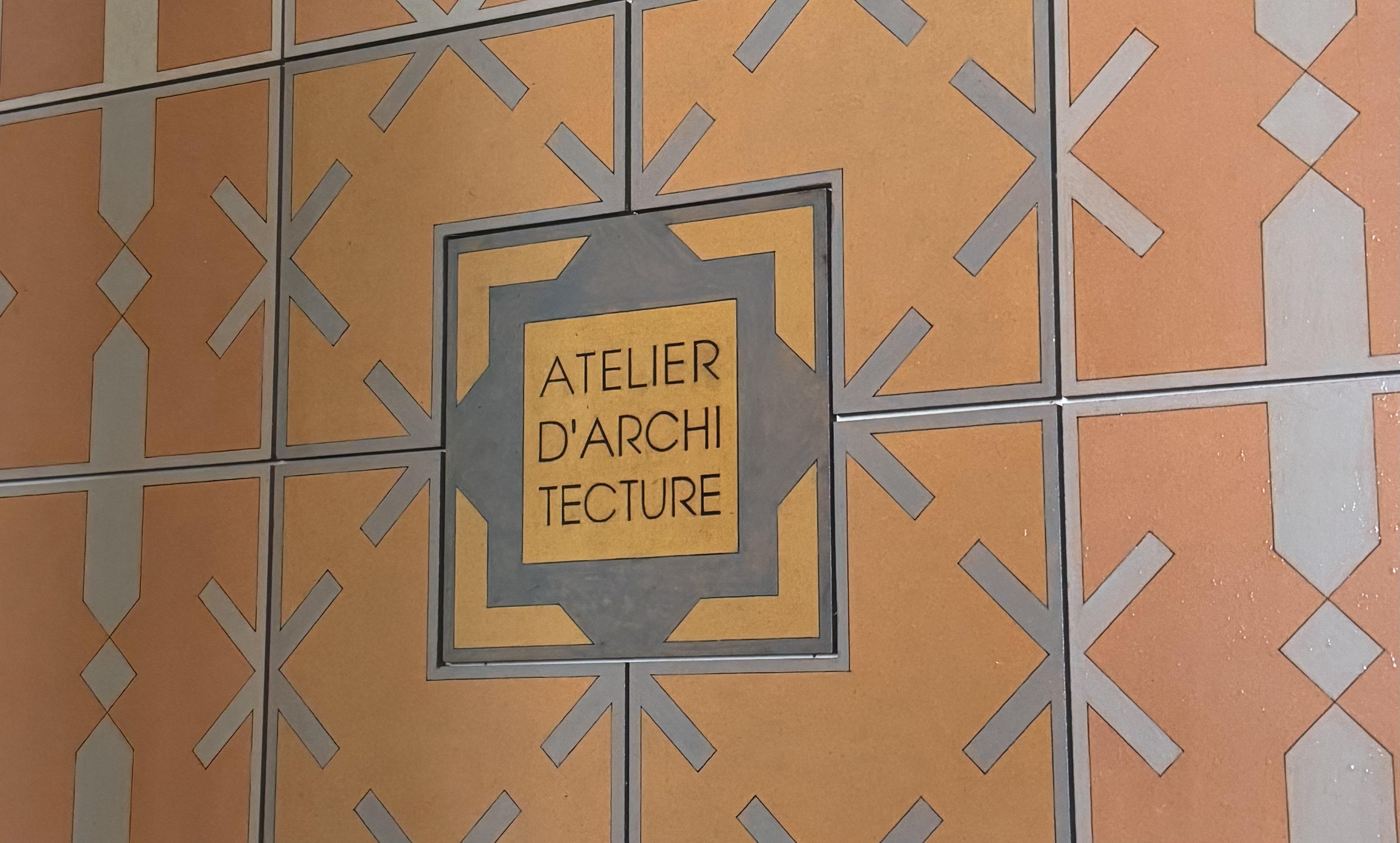 the sign on the door of the office saying atelier d'architecture