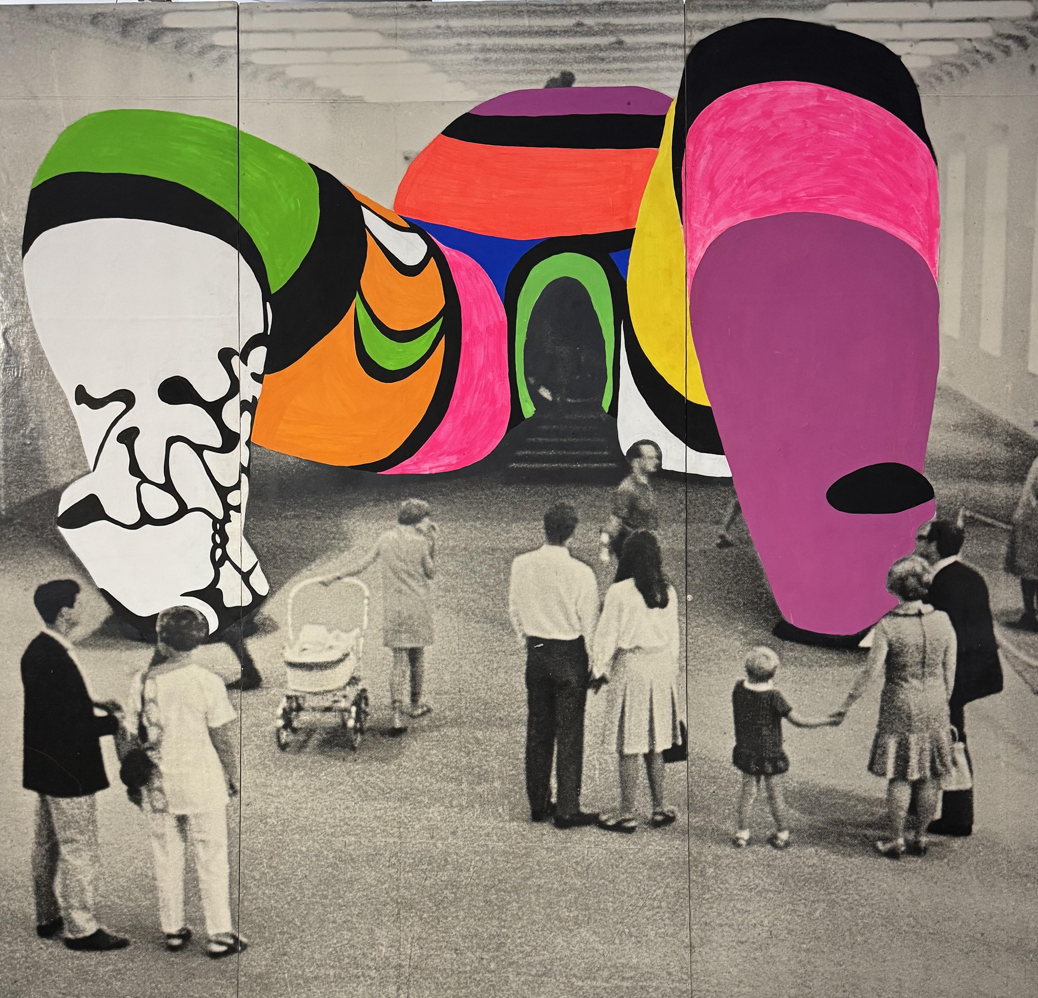 A large sculptured woman lying on her back with her legs open. There are stairs that go up into her vagina. The legs have been painted in lots of different colours. There are a handful of people looking at the piece of art on display