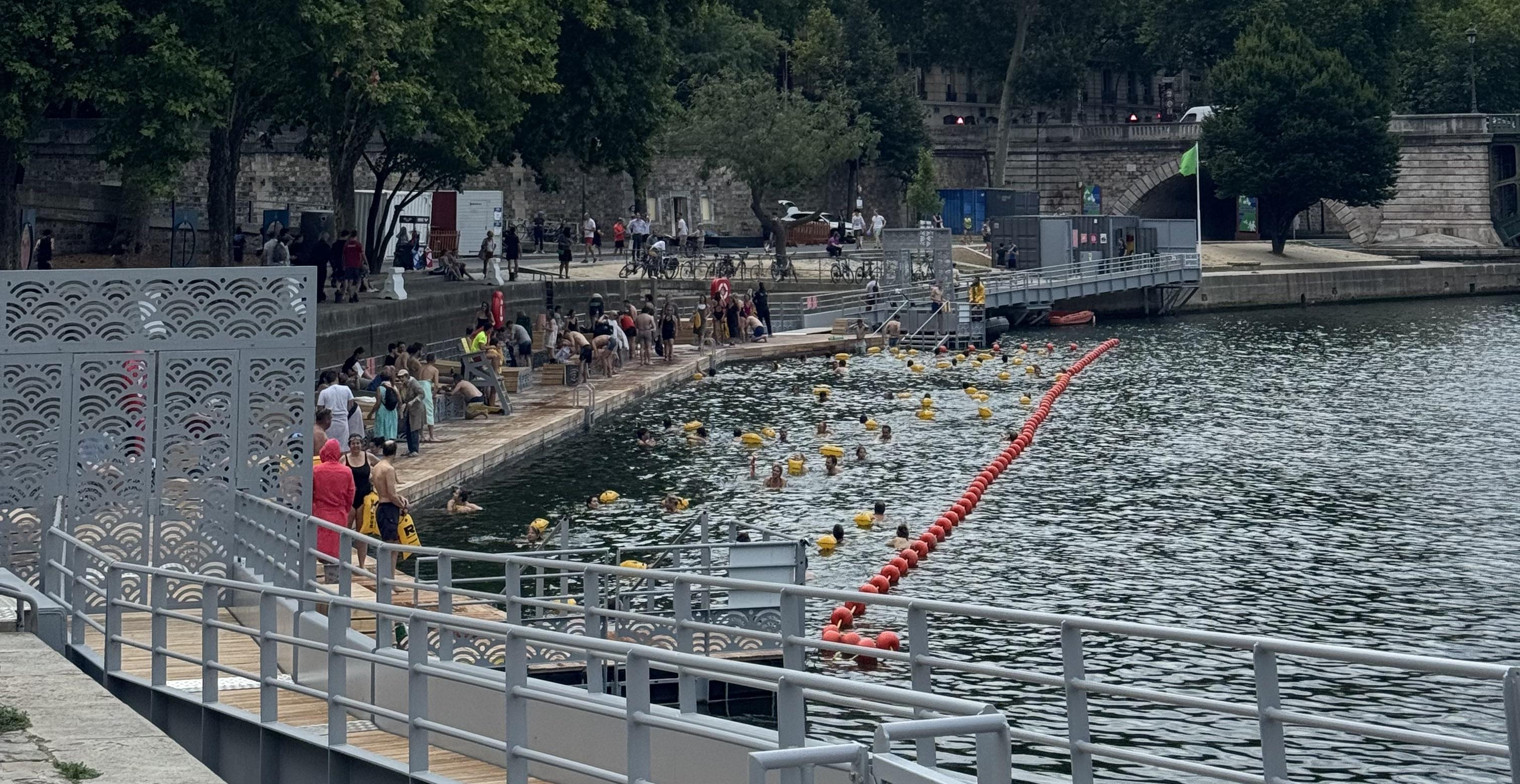 a section of the river where you're allowed to swim in. In the water you can see some people, all of them have a yellow float attached to them