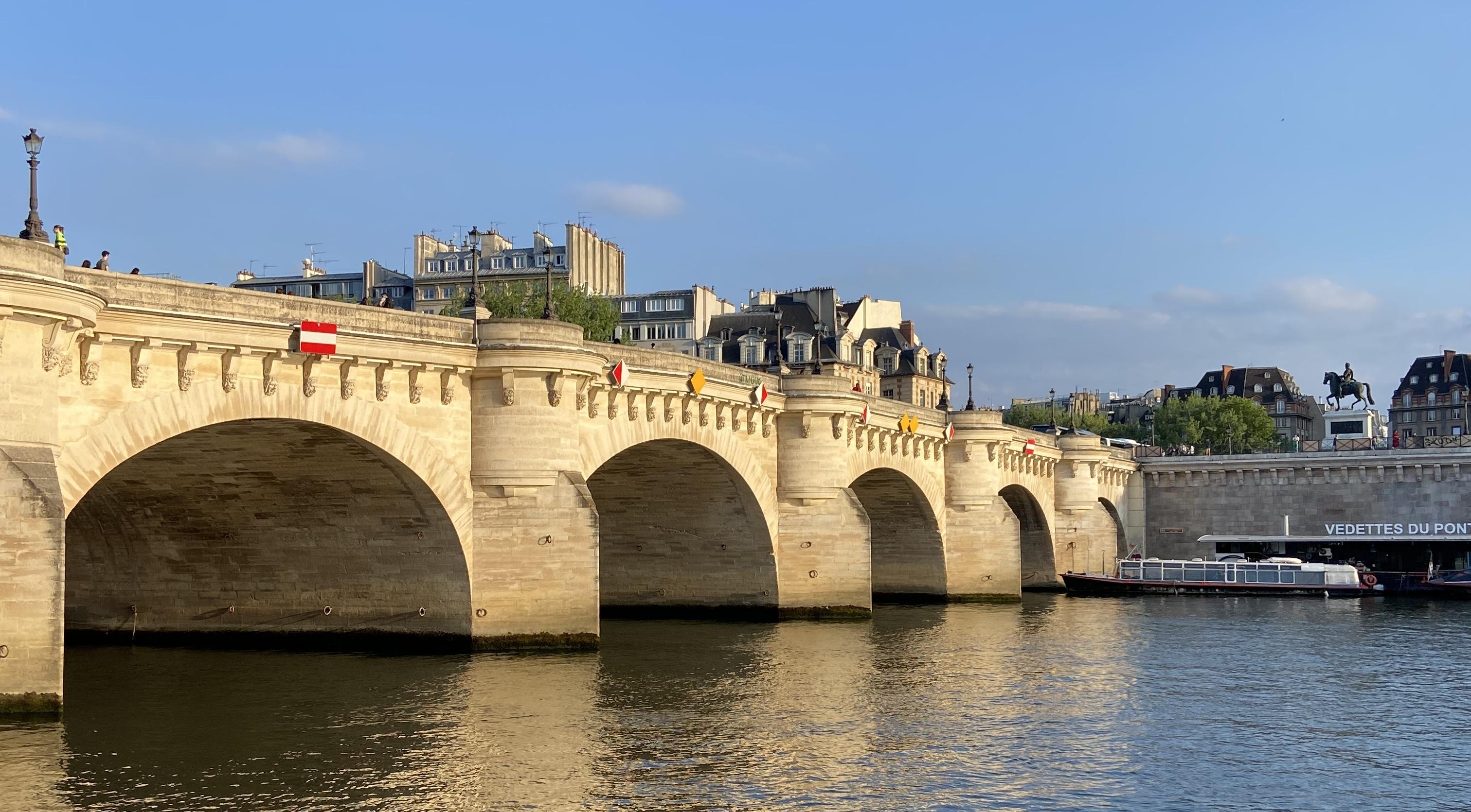 five of the arches connecting pont neuf to the right bank. On the right you can see the statue of Henri IV.