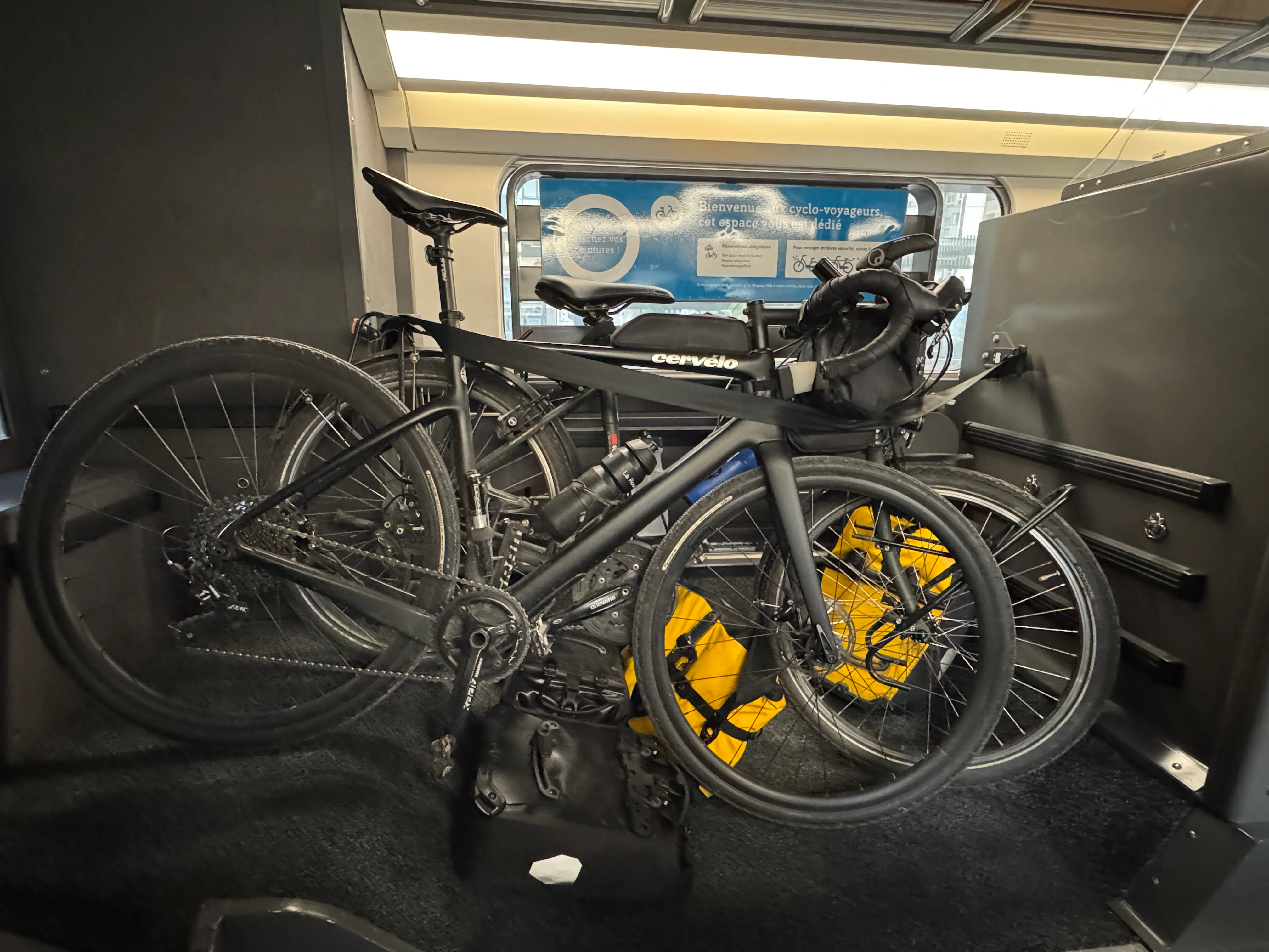 TVG bike storage. Two bikes are stacked next to each other with four bike bags underneath