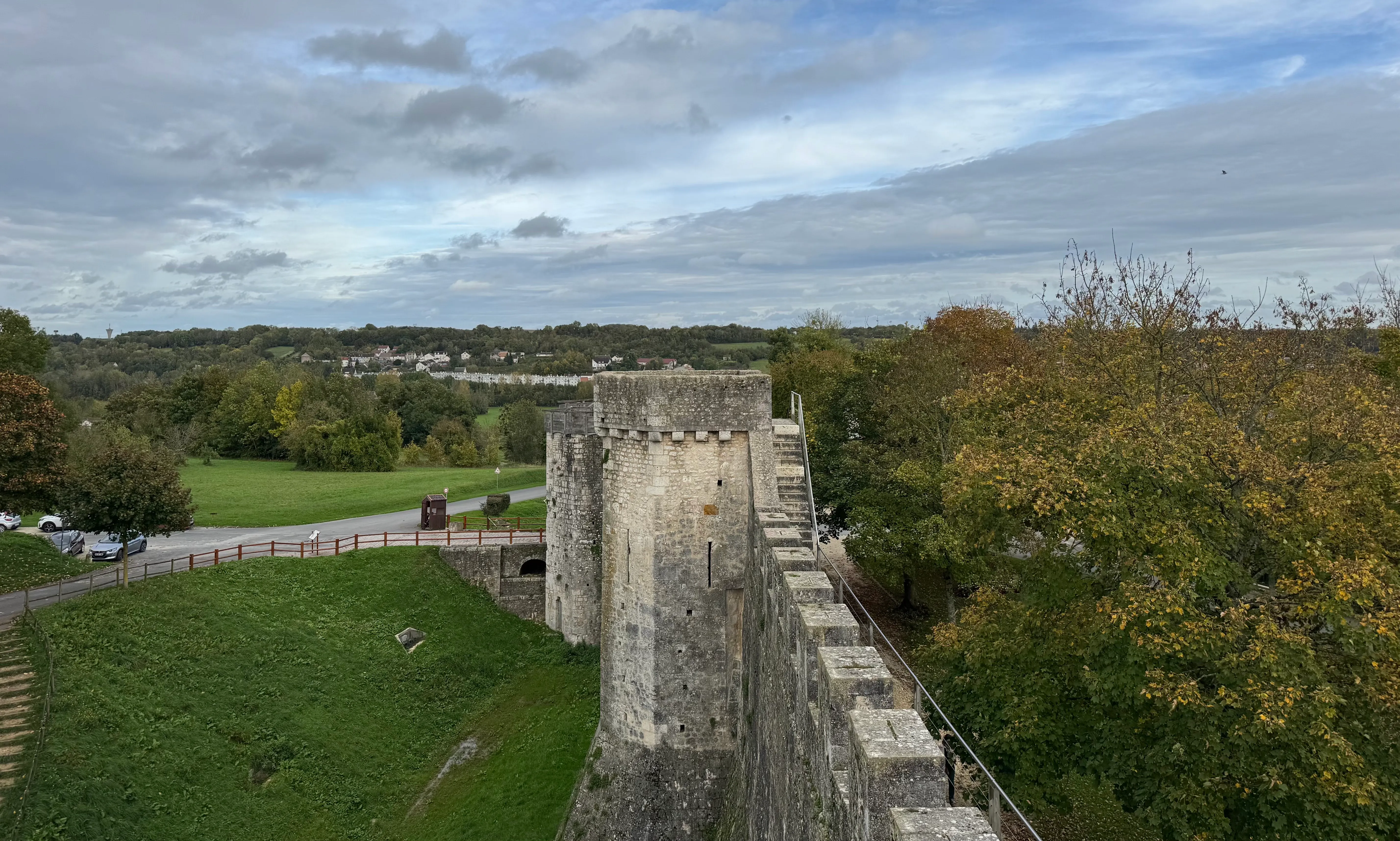 a view from the top of the city walls. Lots of grass and trees surround the wall