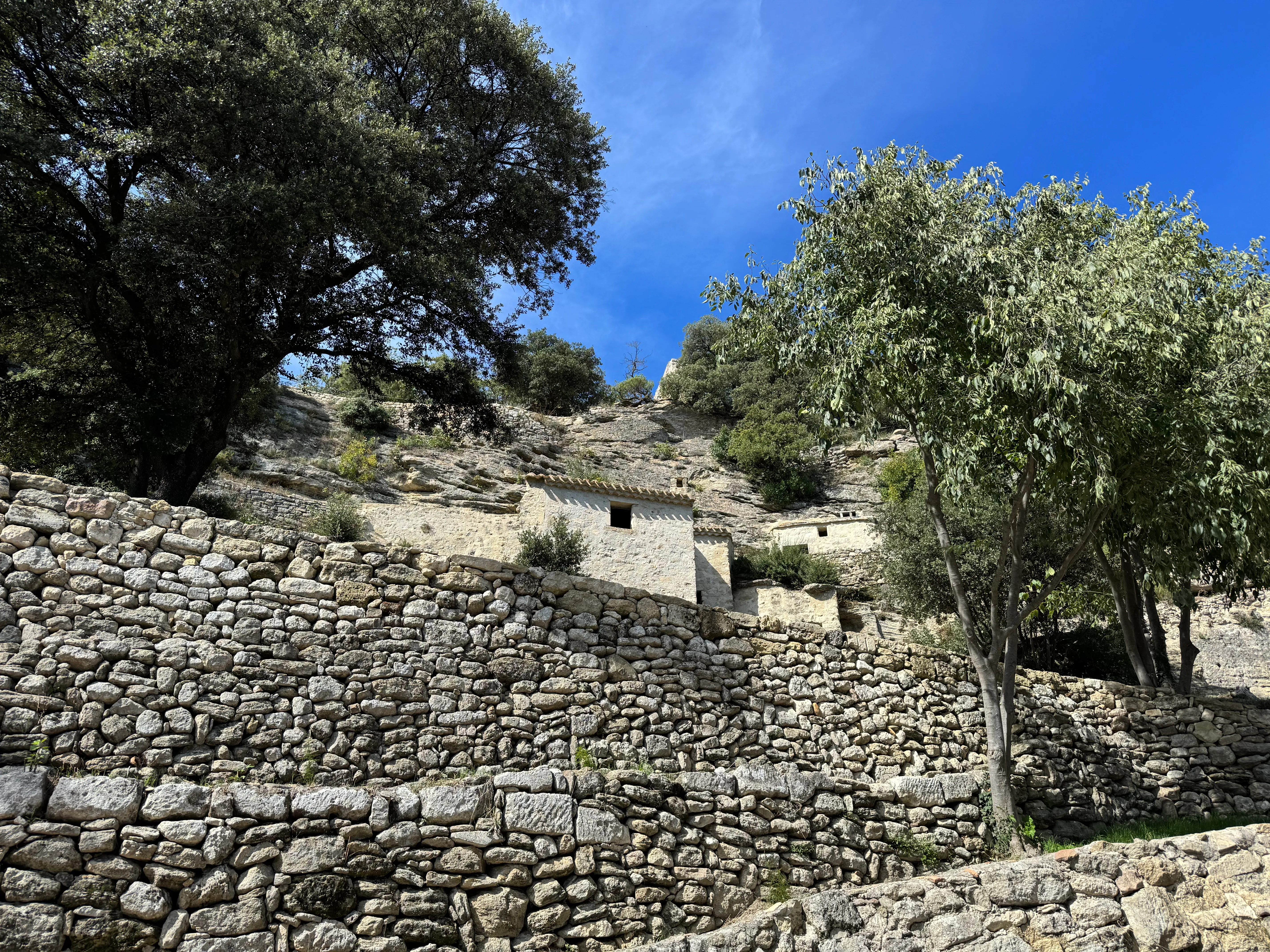 some of the houses behind a stone wall